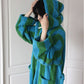 Detail of the color block stripe terry weave and turned back cuff on the cotton hooded bathrobe