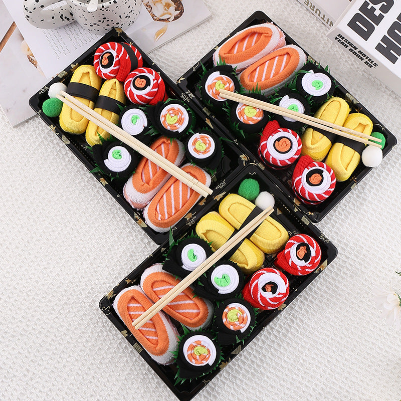 High tube food print crew socks in combed cotton, shown as rolled sushi pieces with toy chopsticks
