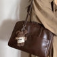 Front view of the brown Retro Pillow Shoulder Bag showing its soft puffed pillow shape