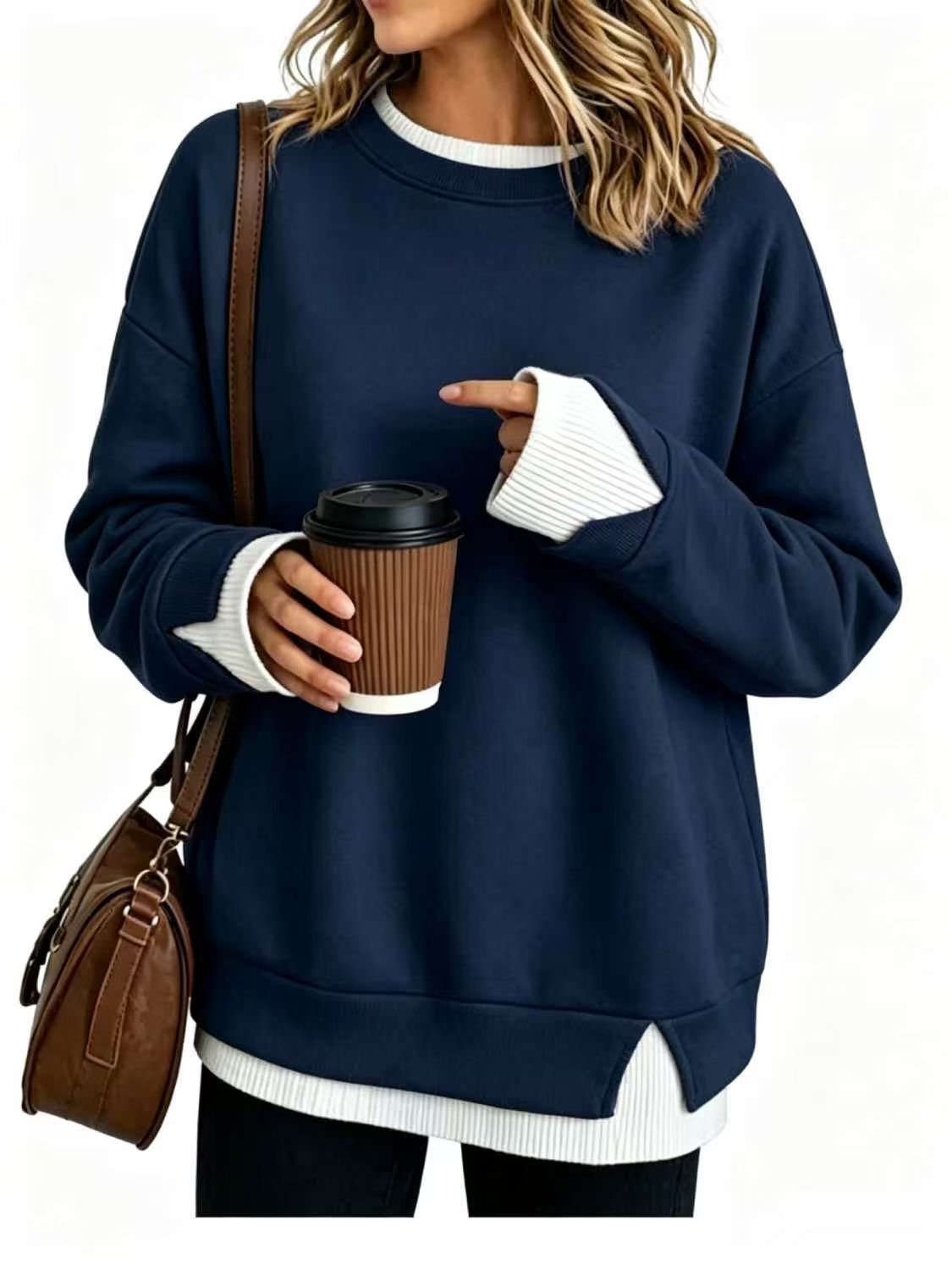 Detail of the contrast white ribbed cuff on a off white pullover sweatshirt