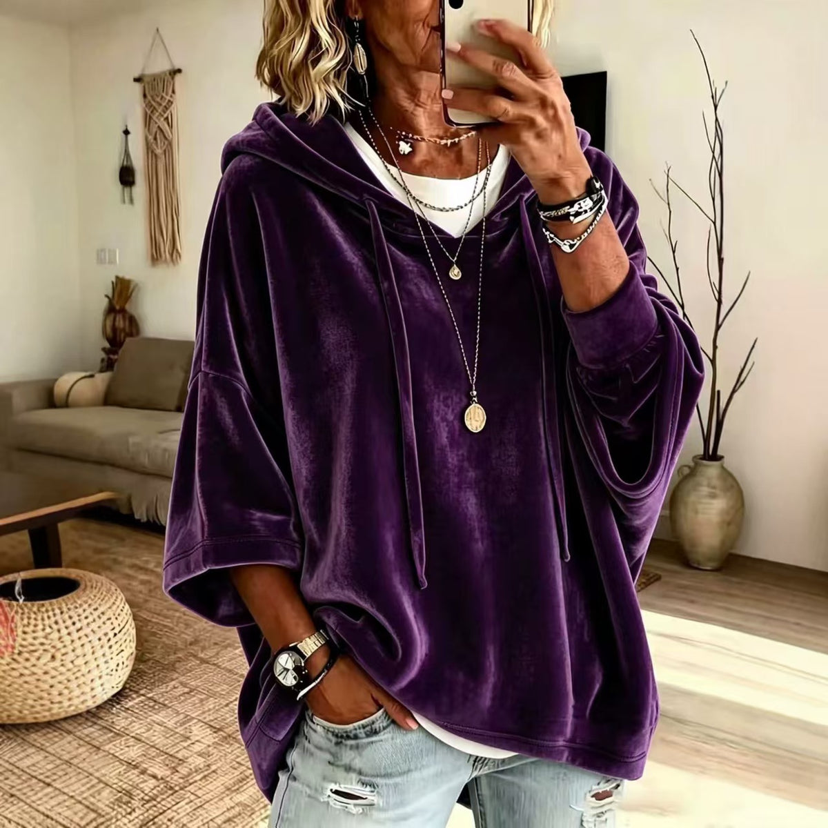 Drawstring hood and roomy body of a loose womens hooded pullover top