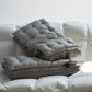 Grey quilted cotton sateen bed pillow with matching mesh gusset on bedding