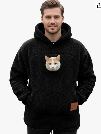 Black fleece pet pouch hoodie on a man with a ginger and white cat riding in the front pouch