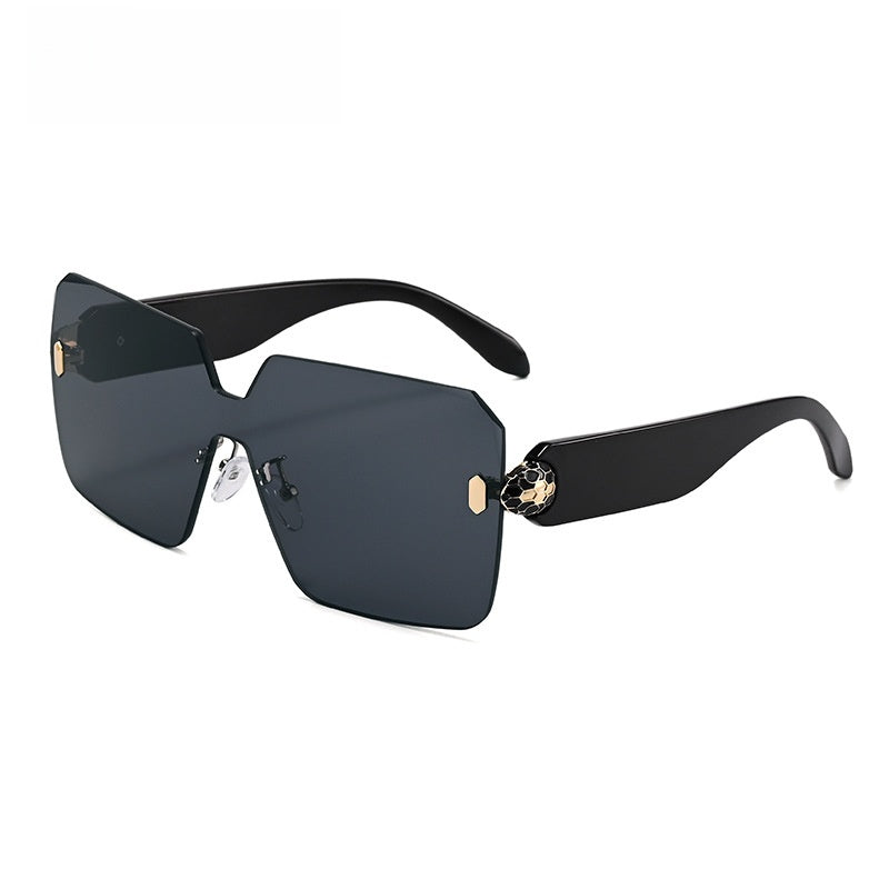 One piece rimless shield lens sunglasses with bevel cut edges and gold toned hinges
