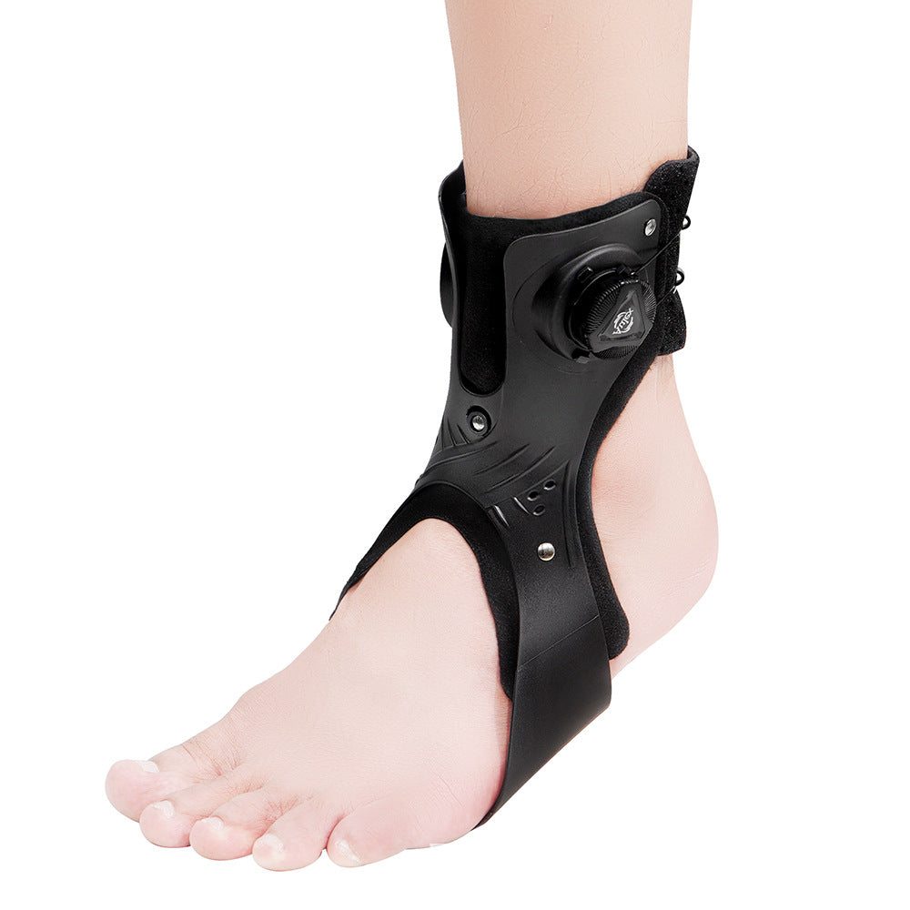 All black dial ankle brace worn on a bare foot, outer side view