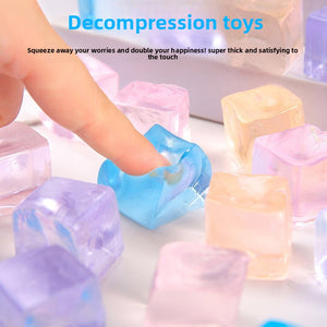 Frosted ice cube shaped squeeze toy held between fingers showing its soft translucent corner