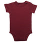 Folded baby short sleeve cotton bodysuit with shoulder snap shoulders on a plain background