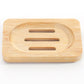 Large rectangular bamboo soap dish with an oval well and three drain slots on a white background