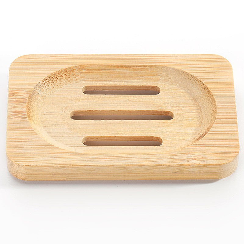 Large rectangular bamboo soap dish with an oval well and three drain slots on a white background