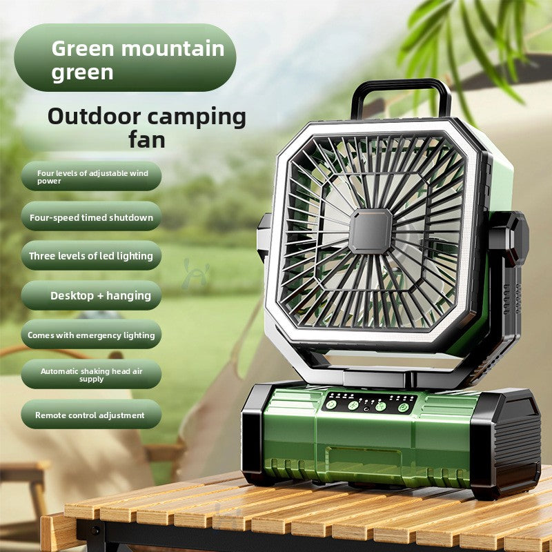 Green camping fan with an oscillating head and remote control on the base
