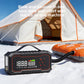 Multi-function unit connected by a hose to an inflatable beside a tent on snow, showing blow and vacuum use
