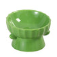 Green glazed scalloped ceramic raised bowl with two side ears on white, not among the listed designs