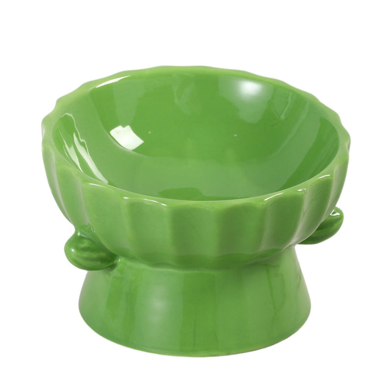 Green glazed scalloped ceramic raised bowl with two side ears on white, not among the listed designs