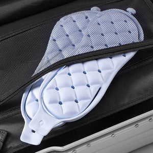 Pair of foldable EVA slippers folded in half at the arch to pack flat for travel