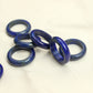 Several lapis lazuli stone band rings grouped on cream cloth, deep blue with scattered gold pyrite