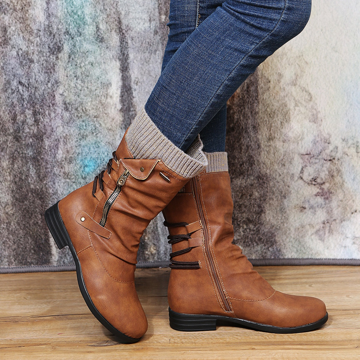 Tan brown slouch mid calf boots with a gray beige knit cuff, zippers and back cords, worn with blue jeans