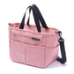 Pink insulated lunch bag with twin top handles and a detachable adjustable shoulder strap clipped on