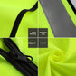 Close ups of the black edge binding, gray reflective strip, zipper and fabric on a fluorescent yellow work vest