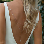 Rose gold tone rhinestone Y drop back necklace worn down a bare back with a white dress