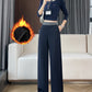 Woman in navy high-waisted wide-leg pants with a gray waistband and a flame graphic marking the fleece lining
