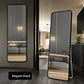 Rectangular wall mirror reflecting a sofa and warm interior in a styled room
