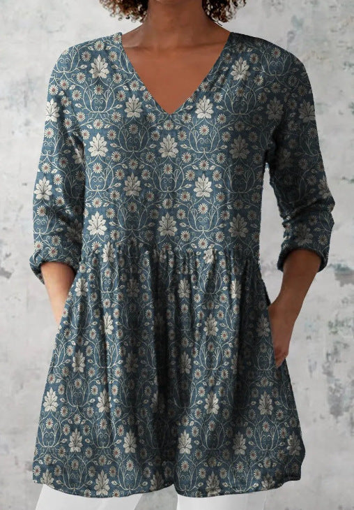 V neck tunic in a digital floral print with a bordered print building toward the hem