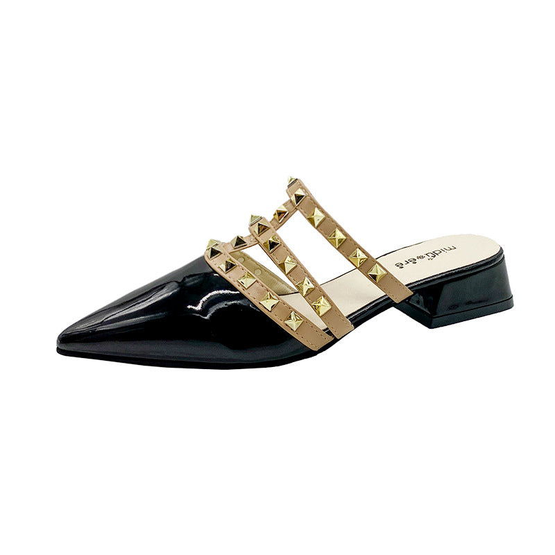 Black patent-look mule with pyramid-studded instep straps side view