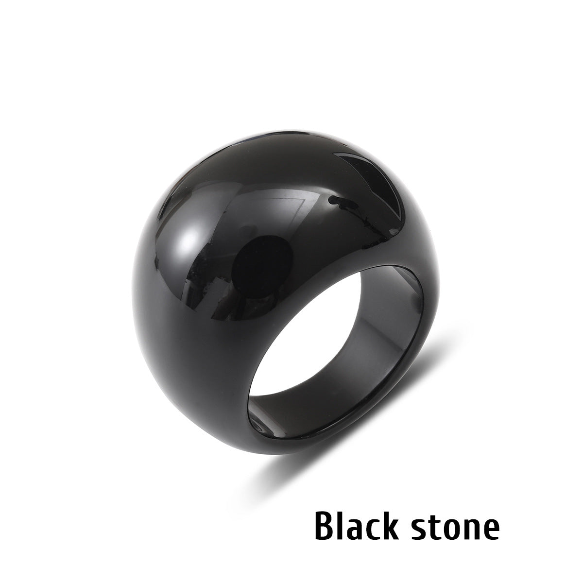 Black stone ring with a smooth domed face on a white background