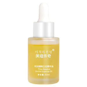 Facial essence oil bottle shown from the side on a plain backdrop