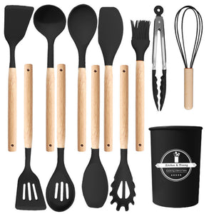 Black silicone utensil set laid out flat with turners, spoons, ladle, spaghetti server, brush, tongs, whisk and holder