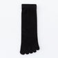Single black five-toe cotton sock laid flat showing the ribbed mid-calf cuff