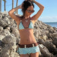 Polka dot triangle bikini seen from the front, sliding cups on the halter cord and frilled brief hem