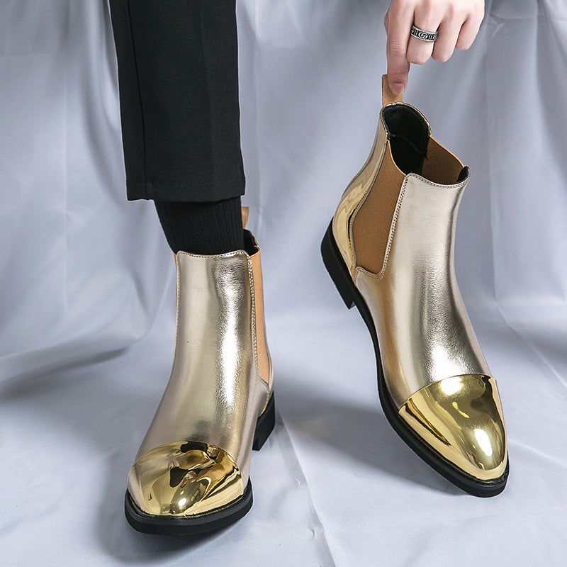 Gold Chelsea ankle boots with mirror-gold cap toes and tan elastic panels worn with black trousers