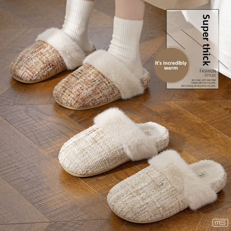 Woman standing in tweed look fur cuff slippers beside a second pair laid on a wooden floor