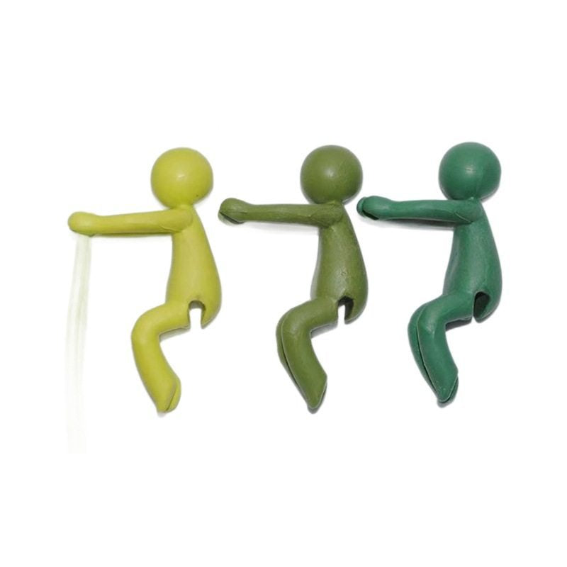 Three green plastic figures in yellow-green, olive and teal green, side by side on a white background