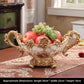Ornate European resin decor piece with a glossy wood grain finish and antiqued gold tone scrollwork trim