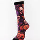 Mid-calf sock on a mannequin printed with skulls and grinning pumpkins on a purple ground