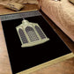 Velvet Islamic prayer mat with a printed mosque lantern design and fringe on a wood floor