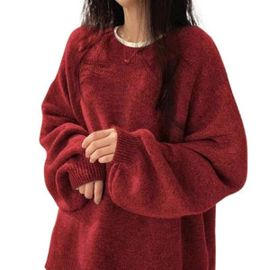 Women's knitted sweater shown layered over a slip dress