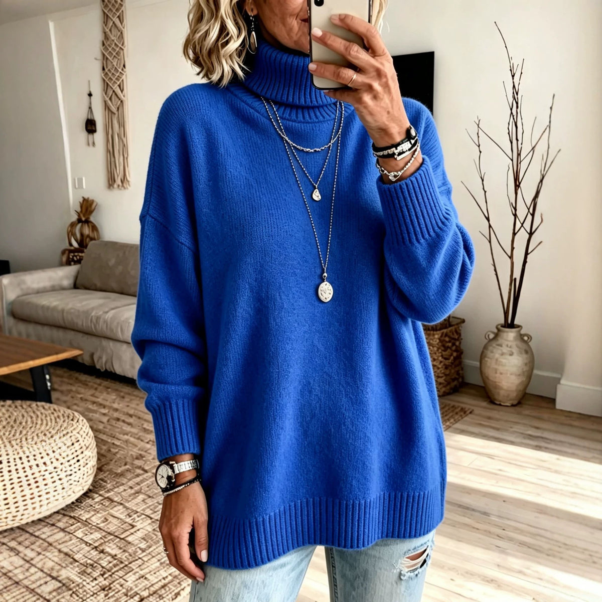 Woman in a royal blue turtleneck knit sweater with drop shoulder sleeves, ribbed cuffs and ribbed hem