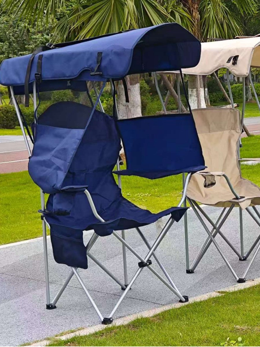 Navy blue foldable camping chair with canopy and front curtain beside a beige chair on a lawn