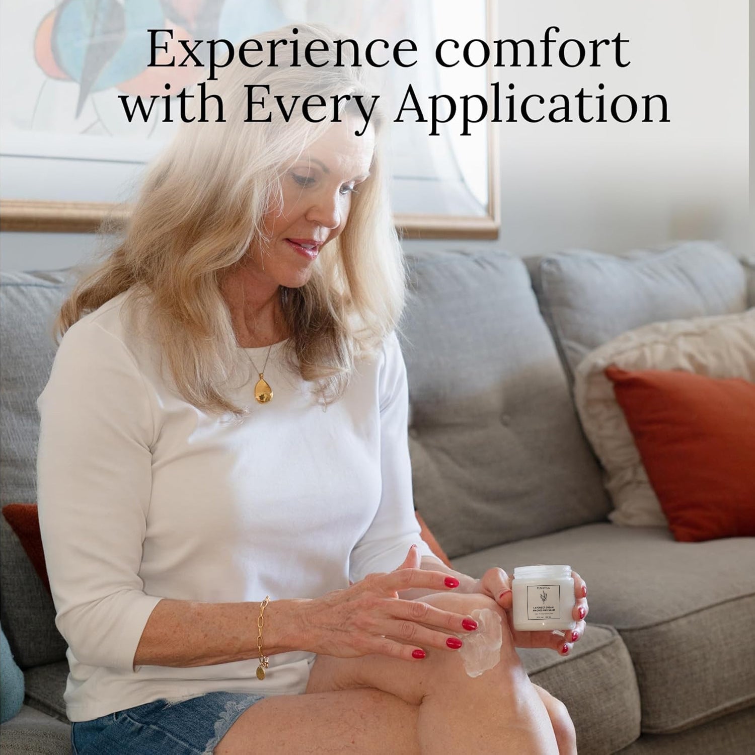 Person applying lavender magnesium body butter to skin while sitting on a sofa