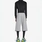 Black loose-fitting sweatpants styled with trainers for a casual day