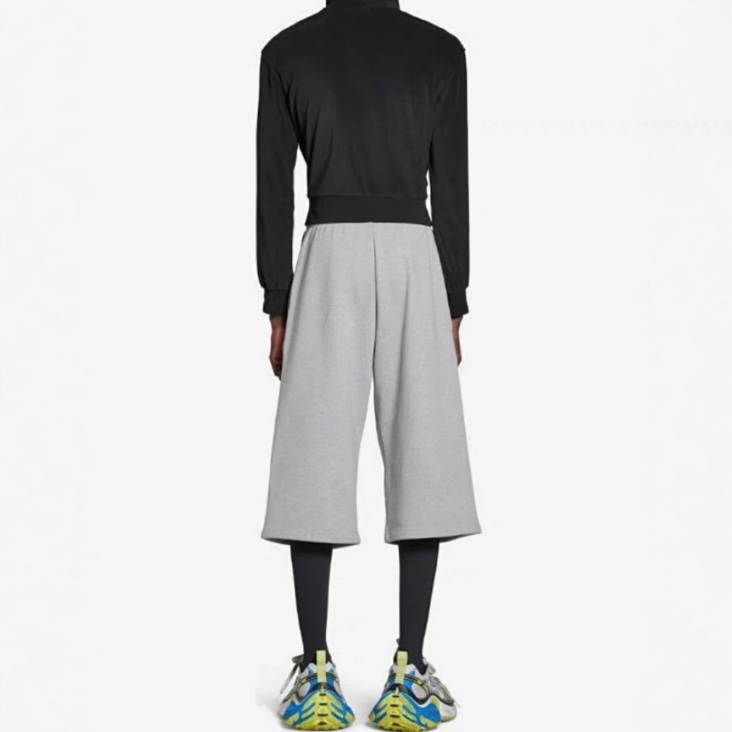 Black loose-fitting sweatpants styled with trainers for a casual day