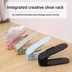 Four adjustable shoe racks in pink, green, blue and black holding trainers on a wooden floor
