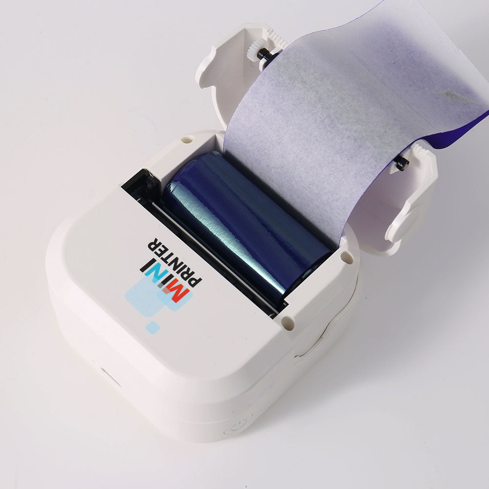 Open white mini printer showing the blue thermal transfer ribbon cartridge above the print head