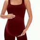 Burgundy maternity ribbed romper side view on a pregnant model seated