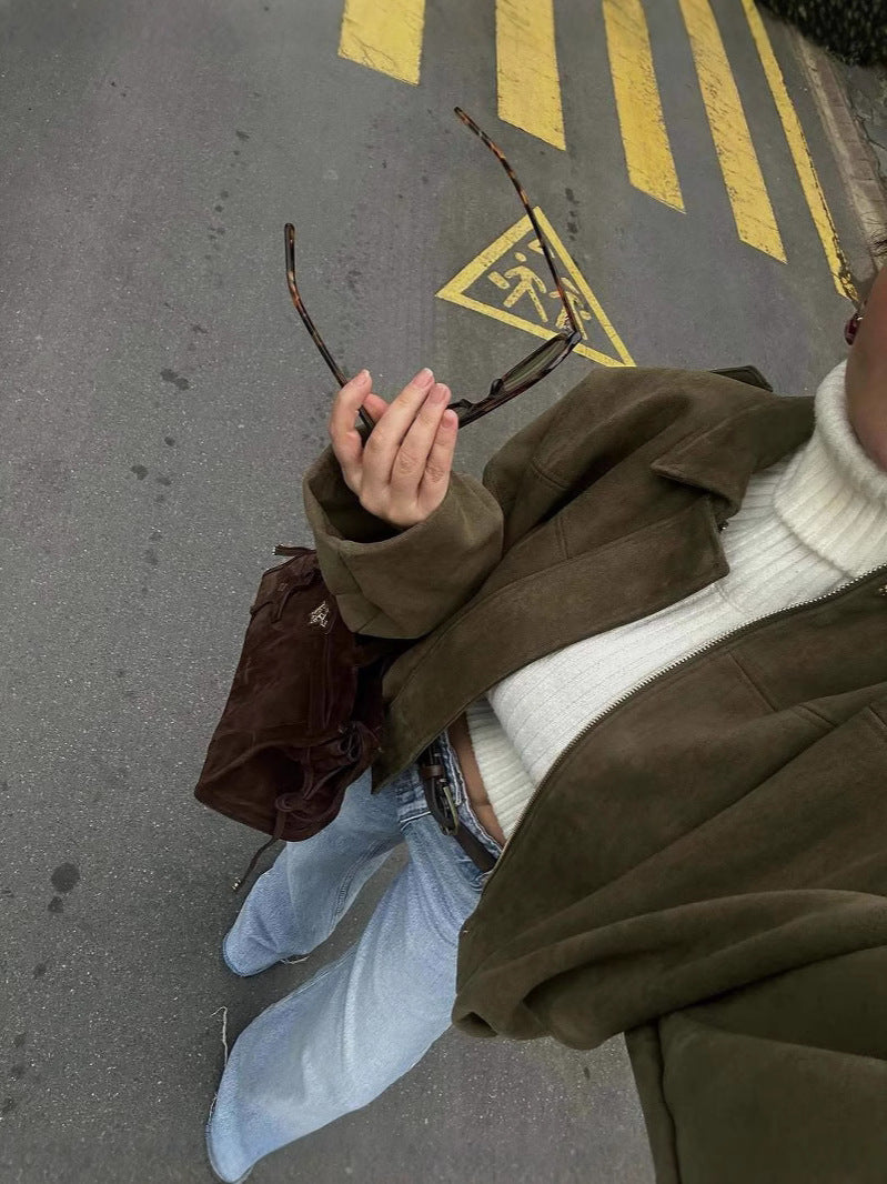 Side angle of the relaxed slightly oversized green zip-up jacket