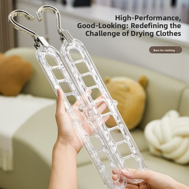 Two hands holding clear nine-hole plastic hanger racks with rotating hooks in a living room