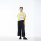 Full length view of yellow Good Mood cropped shirt with black wide leg trousers